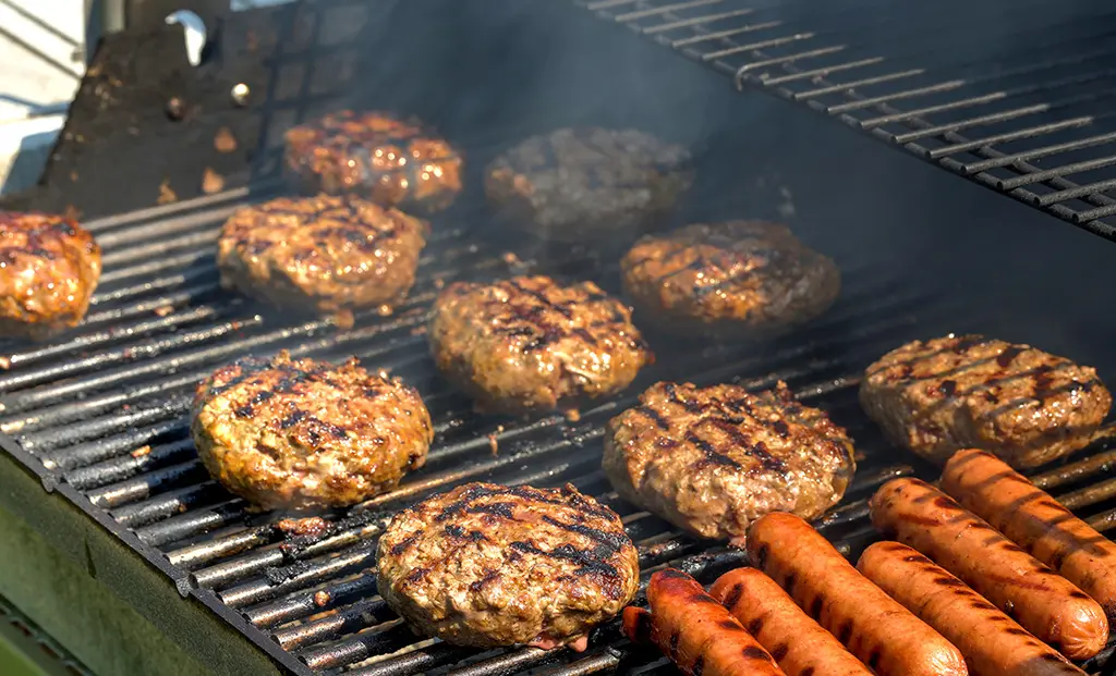 Hamburgers and hotdogs on the grill.