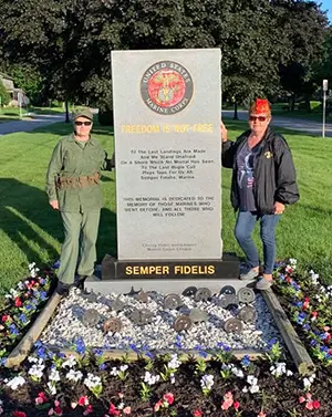 Ellen Leidy next to Marine memorial